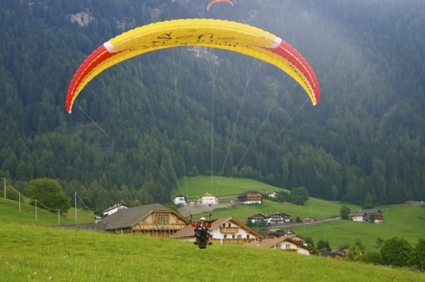 The paragliding landing in Alpe di Siusi (Seiser Alm), Italy