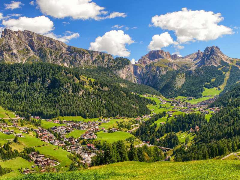 The villages of Val Gardena spread along the valley floor below the Dolomite peaks, where Ortisei, Santa Cristina and Selva hotels sit, Italy