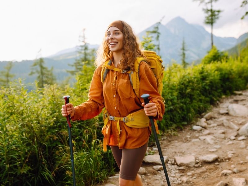 Woman on a hiking trail in Europe — getting in shape for hiking pays off on every step