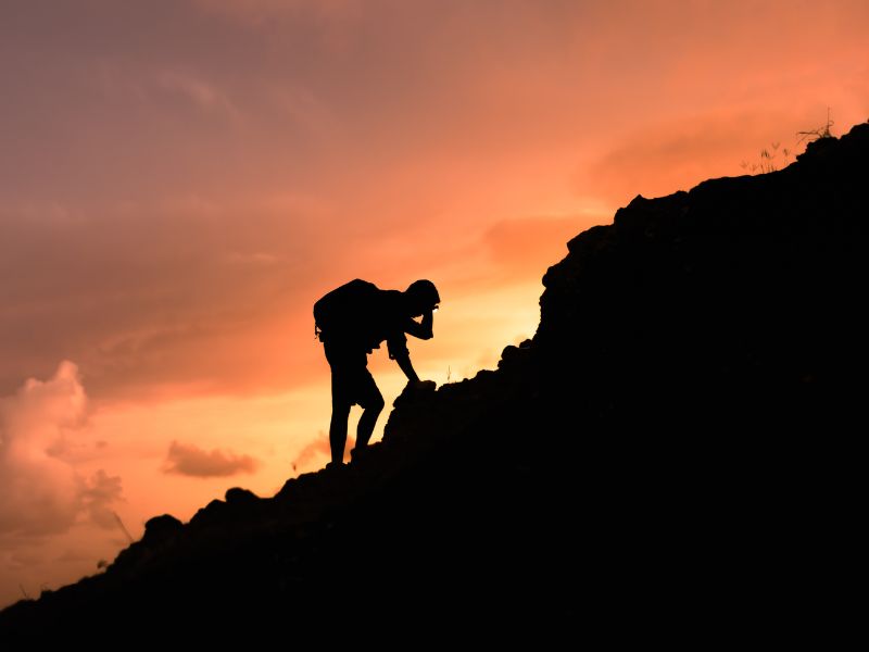 Tired hiker still going at sunset — trail fitness means having something left for the hard days