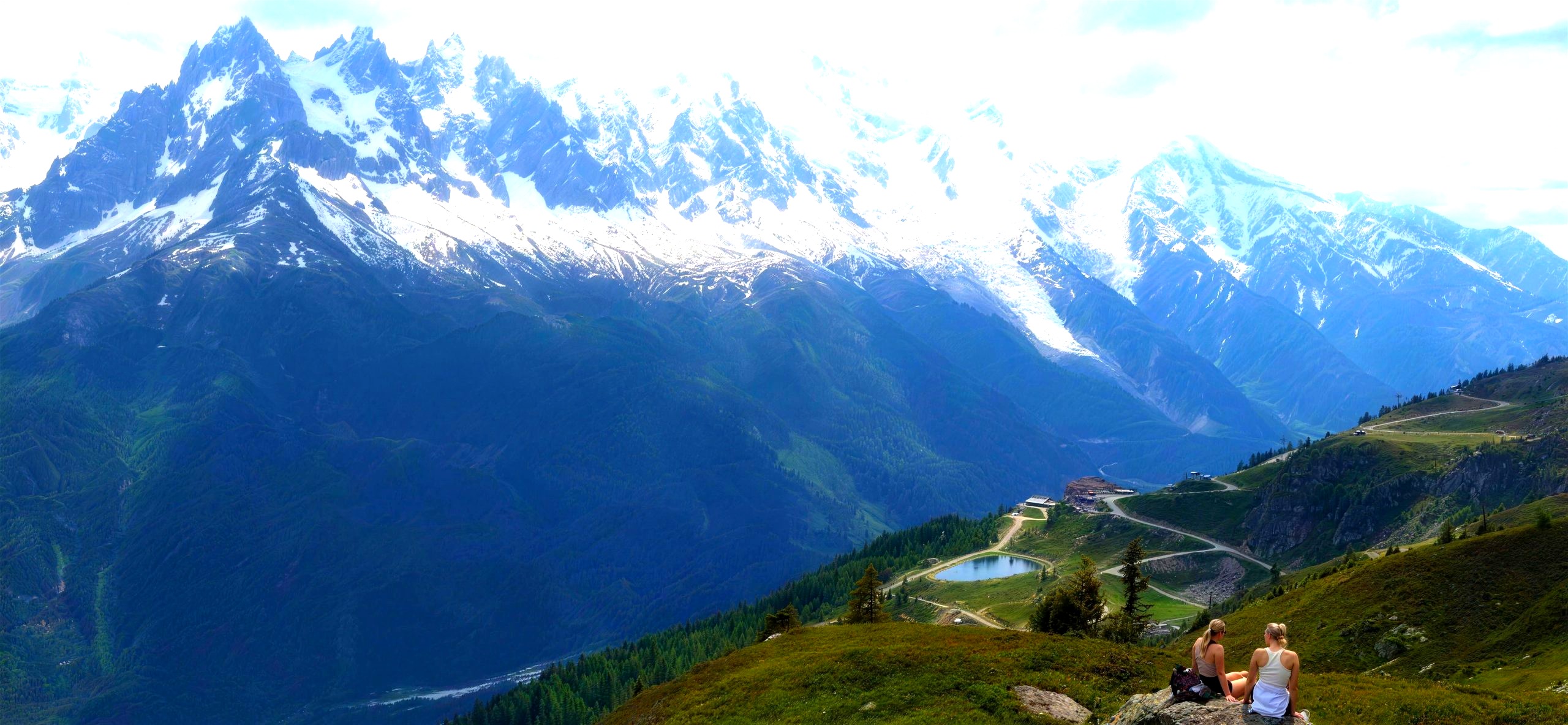 Two hikers admiring the view of Mont Blanc on the Tour du Mont Blanc self-guided hiking tour