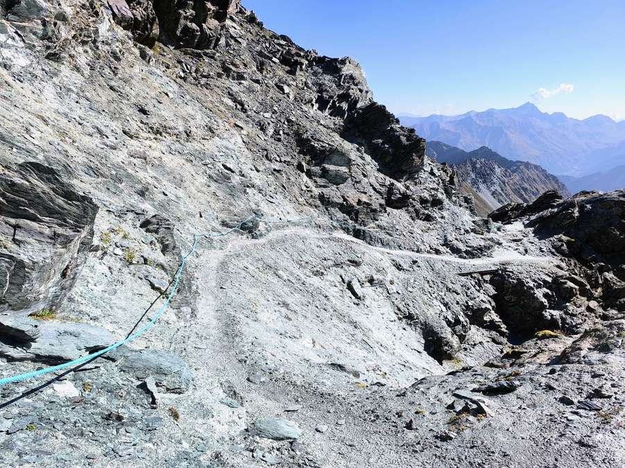Hikers at the fixed-rope section near the Col du Lauson in the Italian Alps