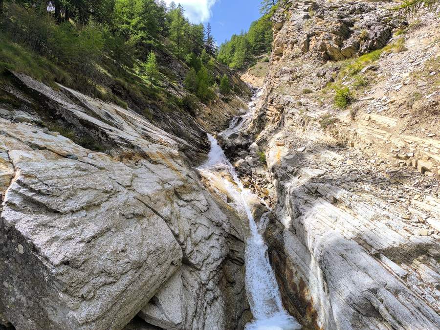 Waterfall beside the trail in Gran Paradiso National Park, Italian Alps