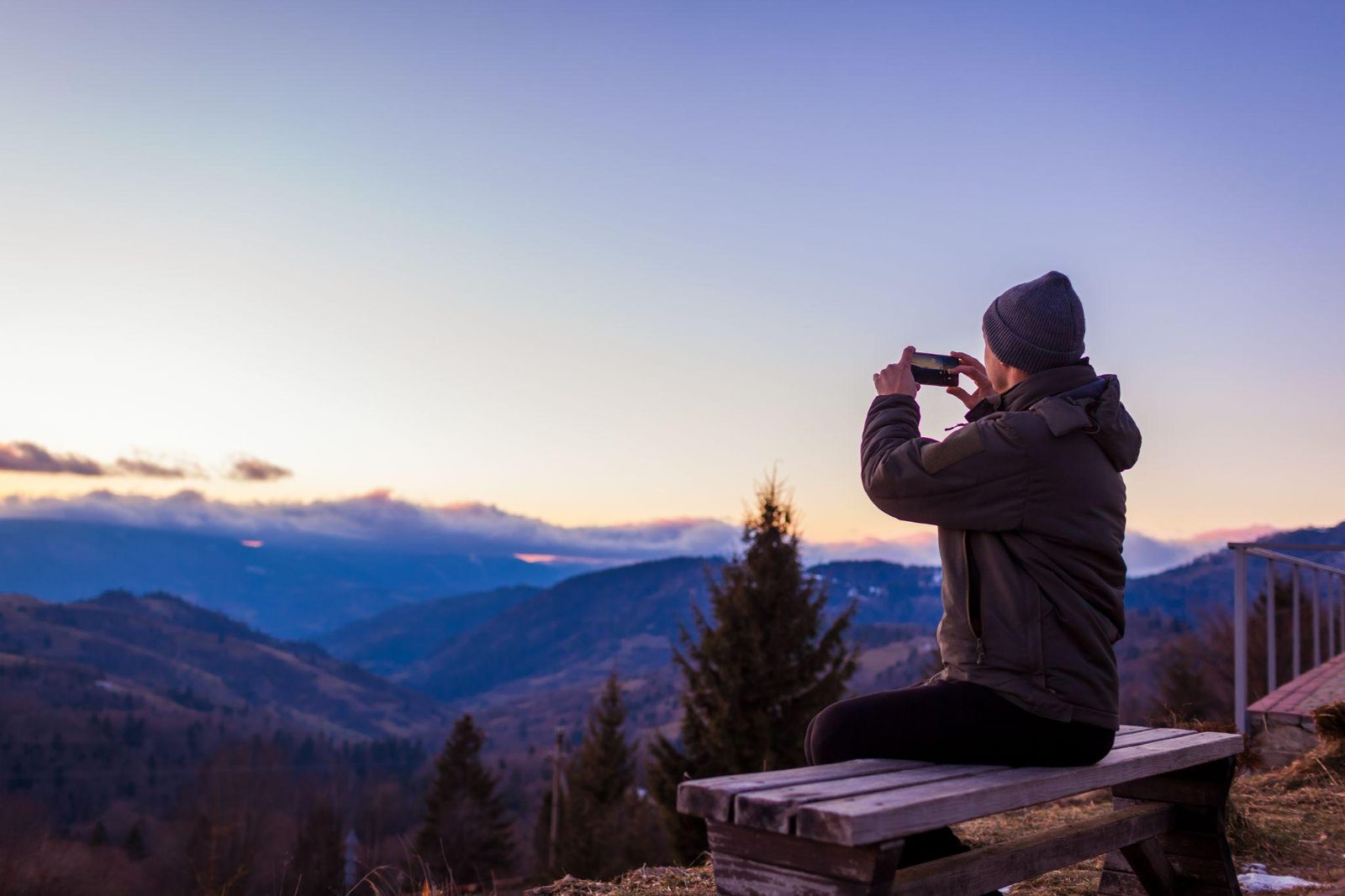 traveler watching sunset over the mountains on a luxury adventure travel trip