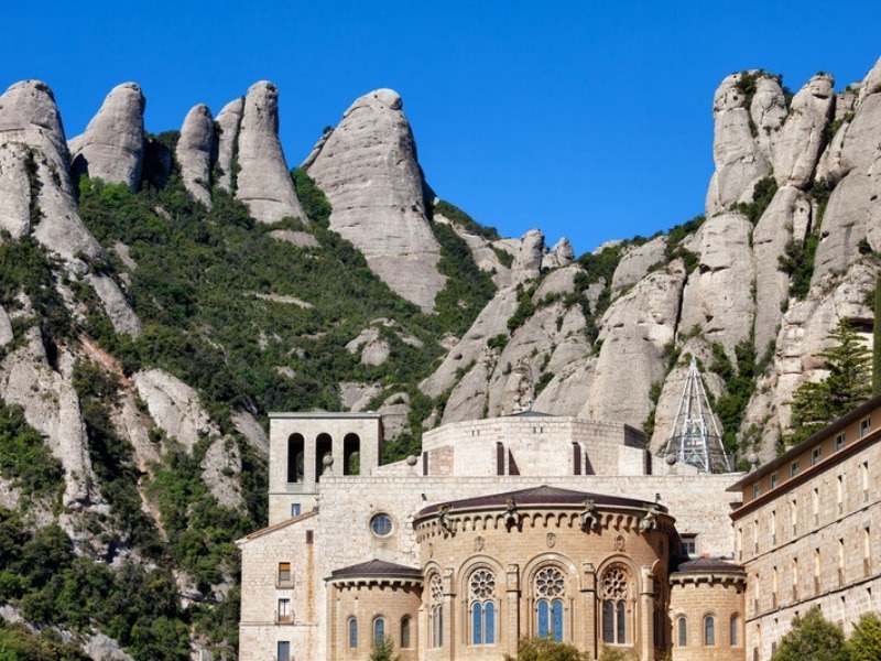 The basilica at Montserrat Monastery with the rock pinnacles rising behind it in Catalonia