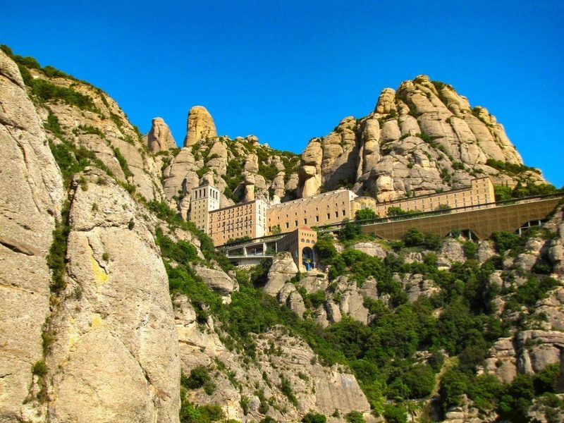 The Montserrat monastery below the rock towers on the Mountains of Catalonia hiking tour