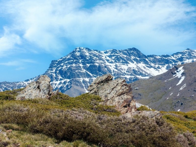 A snow-streaked rocky ridge of the Sierra Nevada above the scrub of the high Alpujarras