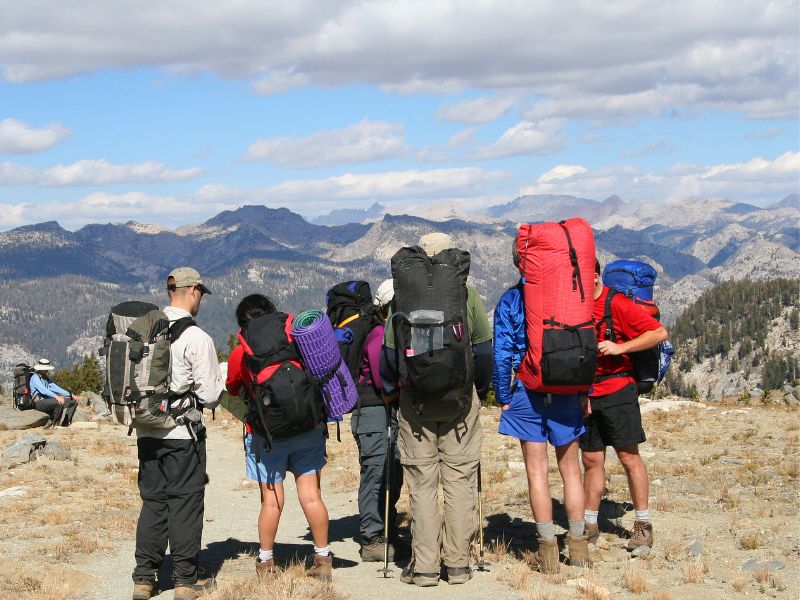 thru-hikers with backpacks looking out over mountain views
