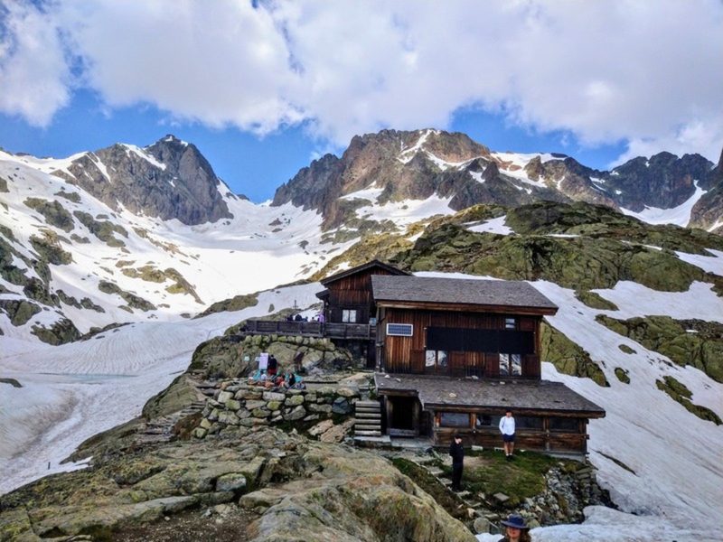 Refuge du Lac Blanc surrounded by snowy peaks on the Tour du Mont Blanc
