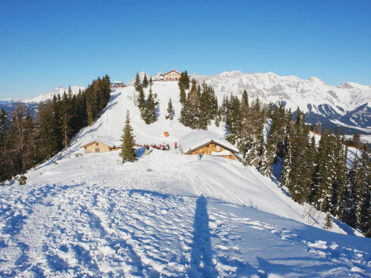 Wooden alpine huts on a snowy ridge near Schladming, the kind of setting the best chalets in Schladming put on your doorstep