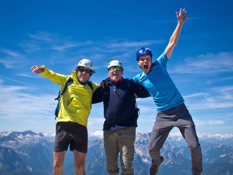 Hikers celebrating on a julian alps summit