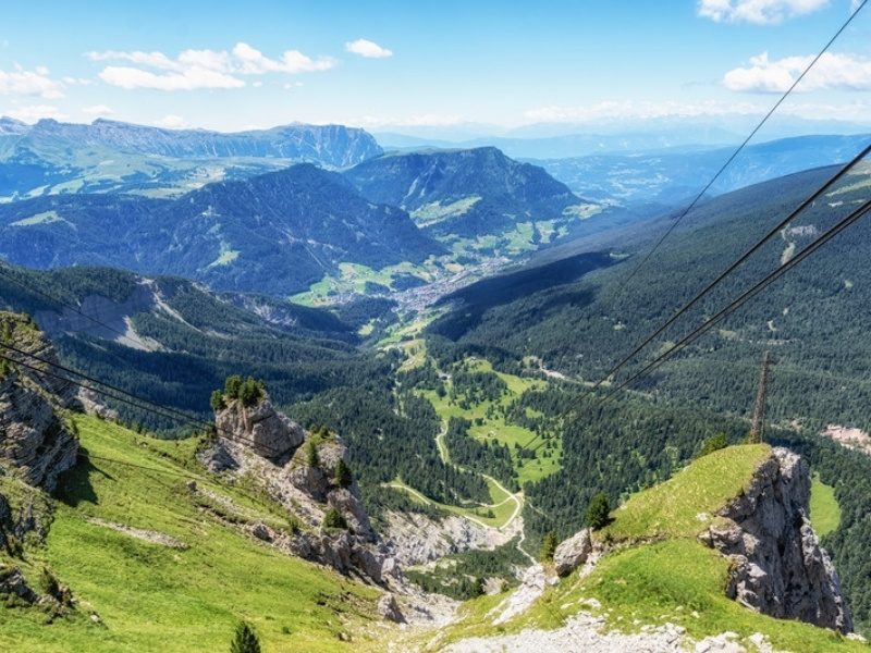View down Val Gardena from a cable car above Ortisei, where the hiking trails start, Dolomites, Italy