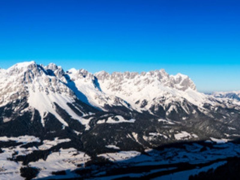 The Wilder Kaiser mountains in winter above the hotels in Scheffau, Austria