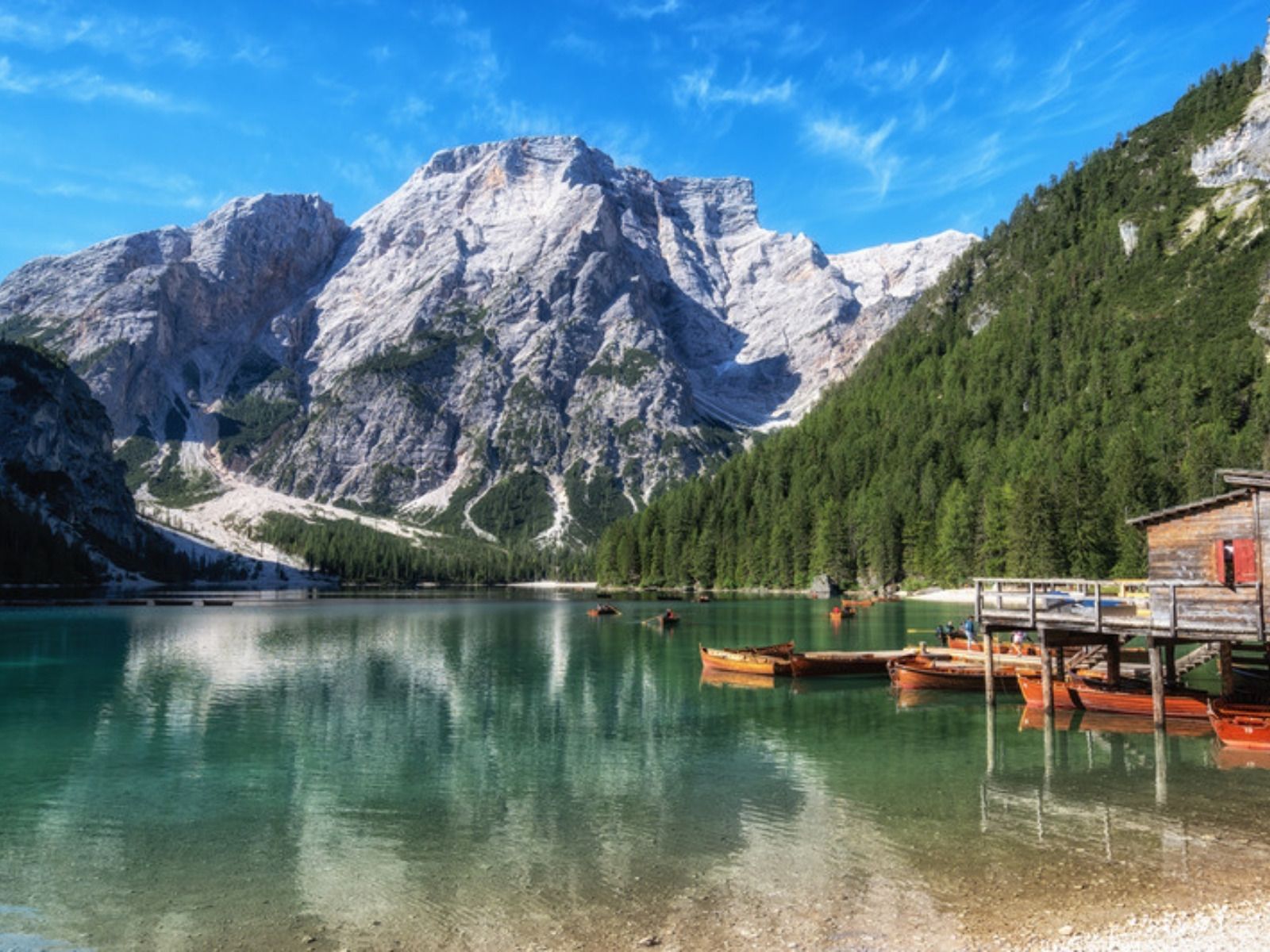 Rowboats and the boathouse on Lago di Braies, the start of the Alta Via 1 in the Dolomites