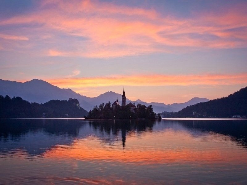 Lake Bled at sunset with the island church, your free day at the end of the Slovenia hut to hut hiking tour