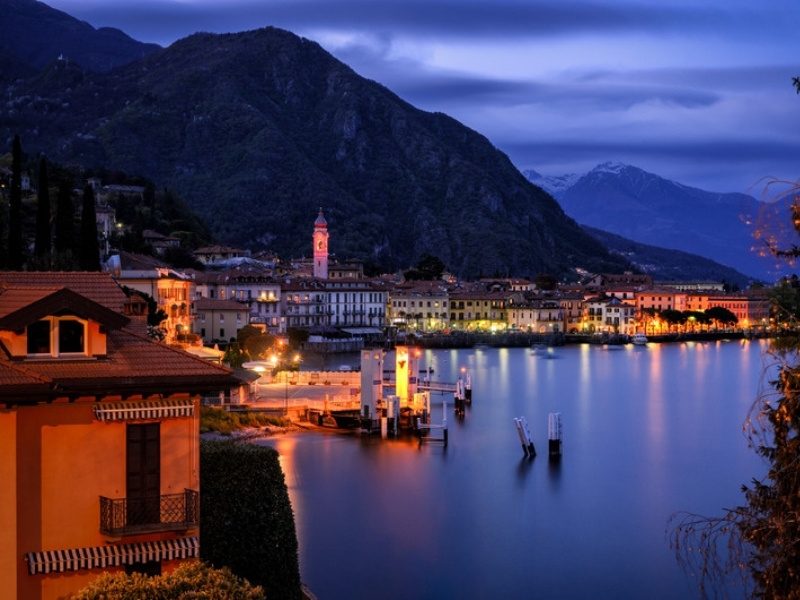Menaggio lakefront and bell tower on Lake Como at dusk, a short walk from the best Menaggio hotels