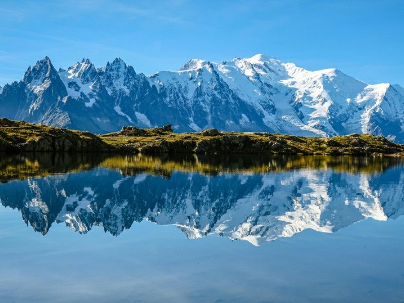 Mont Blanc and the Aiguilles de Chamonix reflected in a still alpine lake above Chamonix in the French Alps