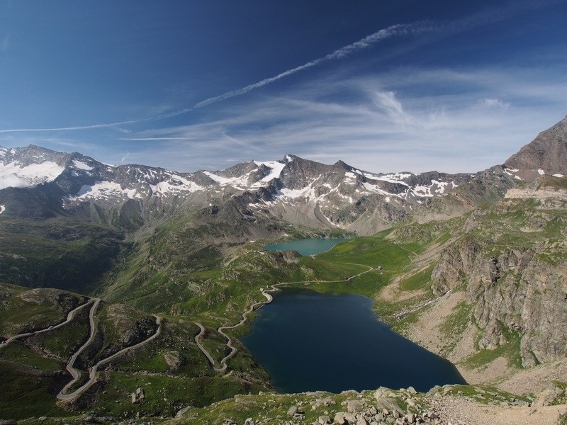 Two blue lakes on the high plateau below snow-capped peaks in Gran Paradiso National Park, Italian Alps