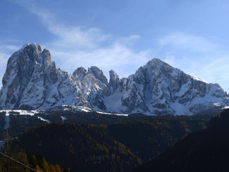 Snow on Sassolungo above Ortisei in winter, when the Ortisei hotels fill with skiers, Dolomites, Italy