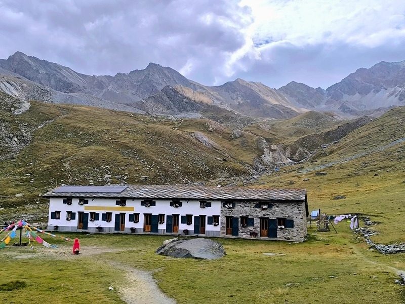 Rifugio Vittorio Sella, the converted royal hunting lodge at 2,584 m (8,480 ft), on the Gran Paradiso hiking tour in the Italian Alps